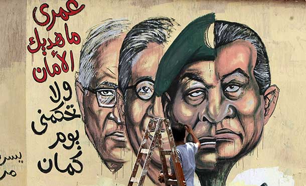 Graffiti of the morphed faces of Egyptian ousted president Hosni Mubarak (R) and military ruler Hussein Tantawi and presidential candidates Amr Mussa (C) and Ahmed Shafiq (L), Cairo’