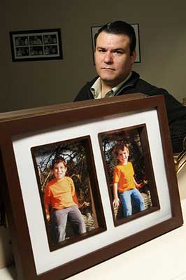 Stephen Watkins with photos of his missing sons, Alexander - Christopher Watkins Photo by - Rene Johnston Toronto Star