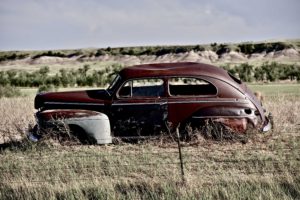 Clunker on Prairie near Pine Ridge Indian Reservation in South Dakota. Abandoned Car in South Dakota.