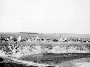 shutterstock_238816231-u-s-troops-surrounding-the-indians-on-wounded-knee-battle-field-miller-studio-gordon-nebraska-photograph-november-10-1913