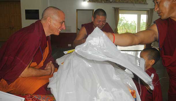 Monks offer white scarves