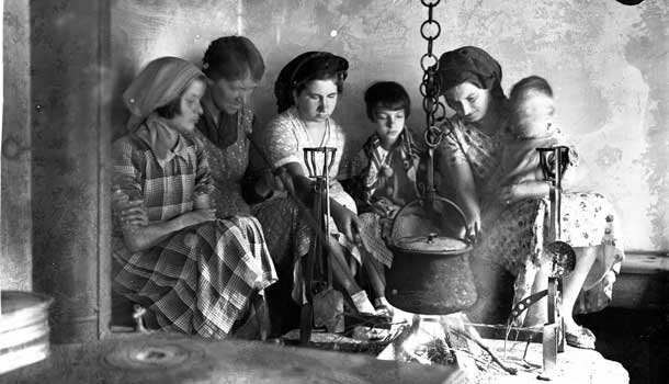 Ladies around cauldron