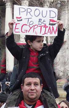 Boy holding board saying Proud to be Egyptian