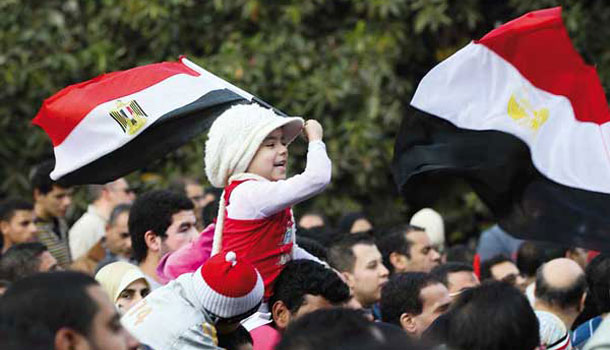 Girl holding flag during Egyptian revolution