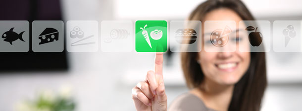 Woman choosing vegetables on a digital display