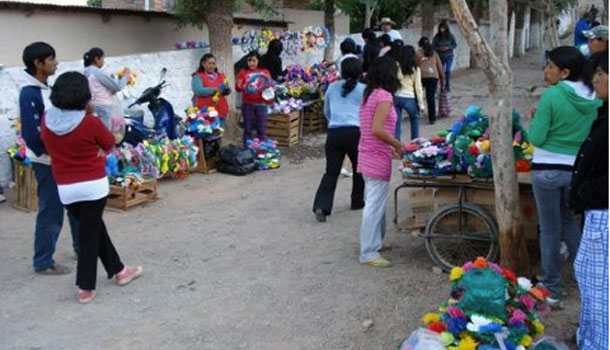 Sale of flowering and the entrance of the cemetery in Tilcara.