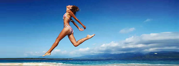 Girl jumping on the beach